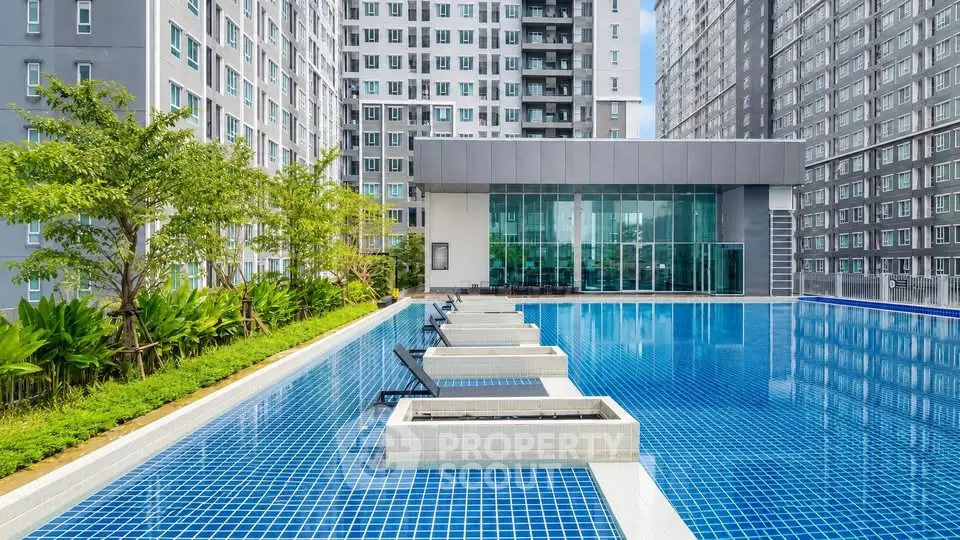 Luxurious apartment complex with stunning outdoor pool and modern architecture.