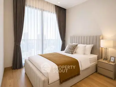 Elegant bedroom with large window and modern decor in a luxury apartment.