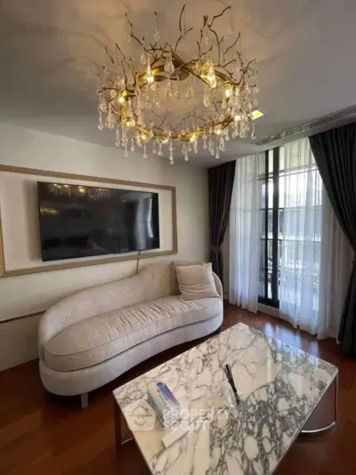 Luxurious living room with elegant chandelier and marble coffee table