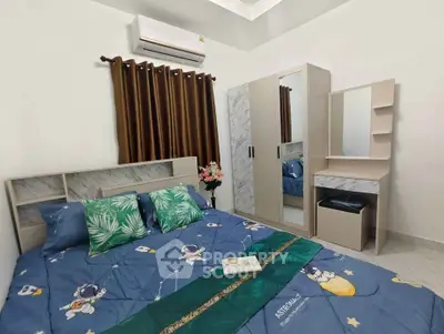 Cozy bedroom with modern furniture and air conditioning, perfect for relaxation.
