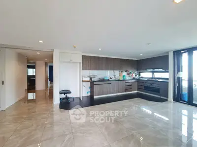 Spacious modern kitchen with sleek cabinetry and open layout in luxury apartment