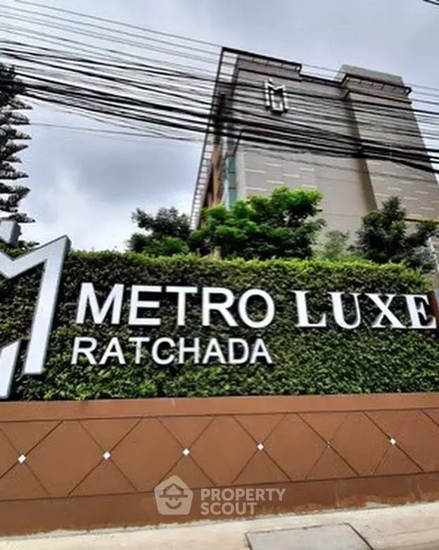 Modern Metro Luxe Ratchada building with lush greenery and stylish signage.