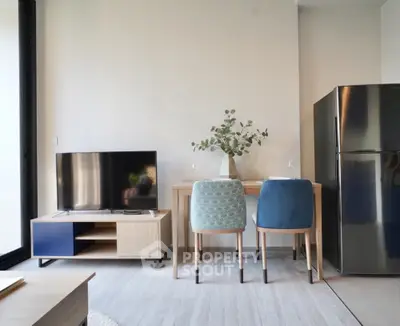 Modern living room with stylish furniture and sleek refrigerator