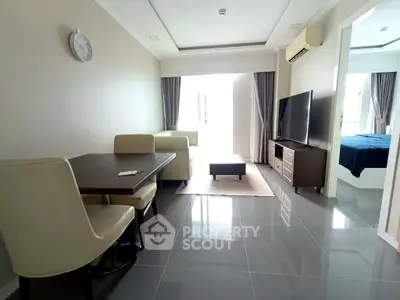 Modern living room with sleek furniture and natural light, perfect for relaxation and entertainment.
