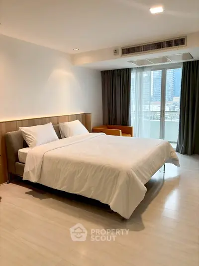 Spacious modern bedroom with city view and natural light