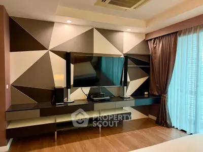 Modern living room with geometric wall design and sleek entertainment center