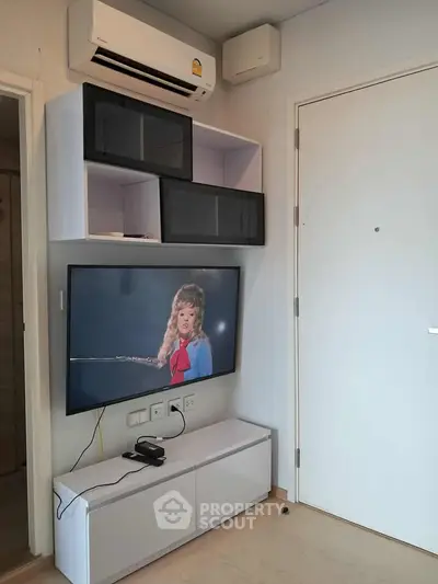 Modern living room with wall-mounted TV and air conditioning unit