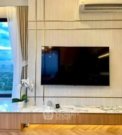 Modern living room with wall-mounted TV and panoramic window view.