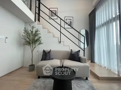 Modern living room with stylish decor and staircase in a contemporary apartment