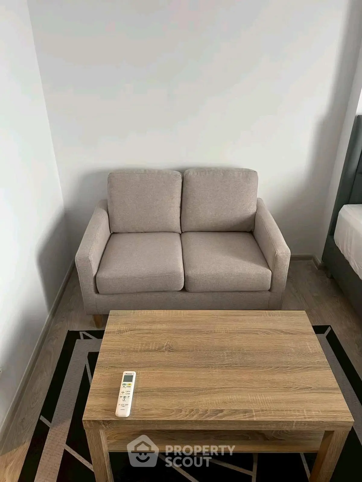 Cozy living room with modern sofa and wooden coffee table, perfect for relaxation.