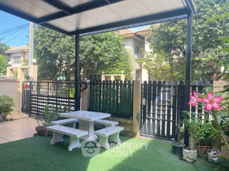 Charming garden patio with seating area and lush greenery