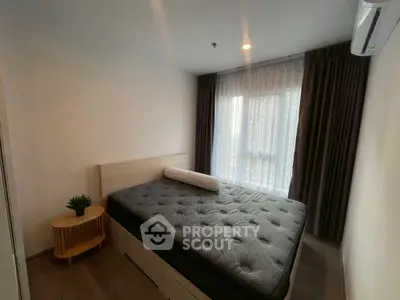 Cozy bedroom with modern decor and large window for natural light