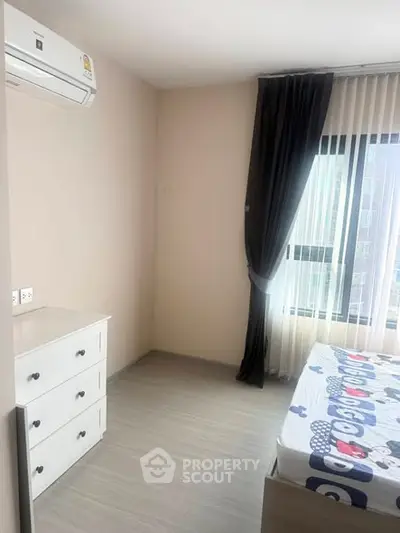 Bright bedroom with modern air conditioning and stylish decor in a high-rise apartment.