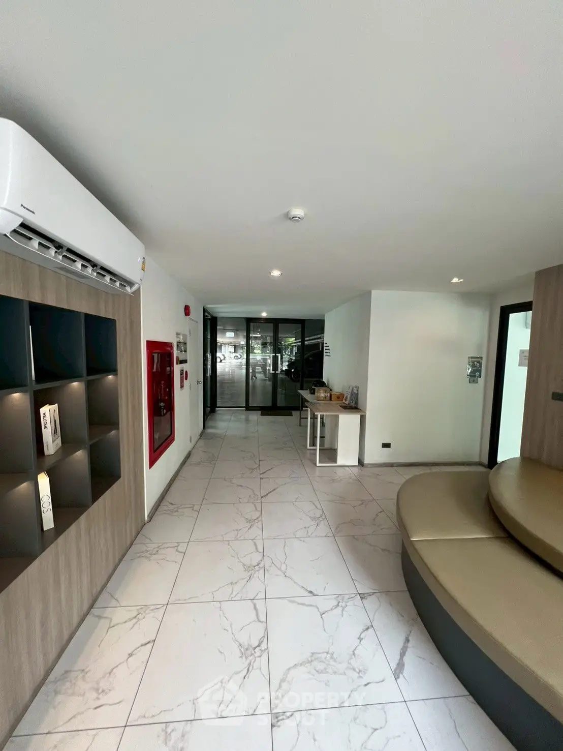 Modern building entrance with sleek design and marble flooring