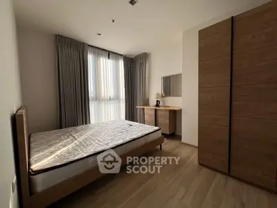 Spacious bedroom with wooden furniture and natural light