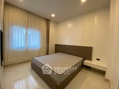 Modern minimalist bedroom with sleek design and natural light