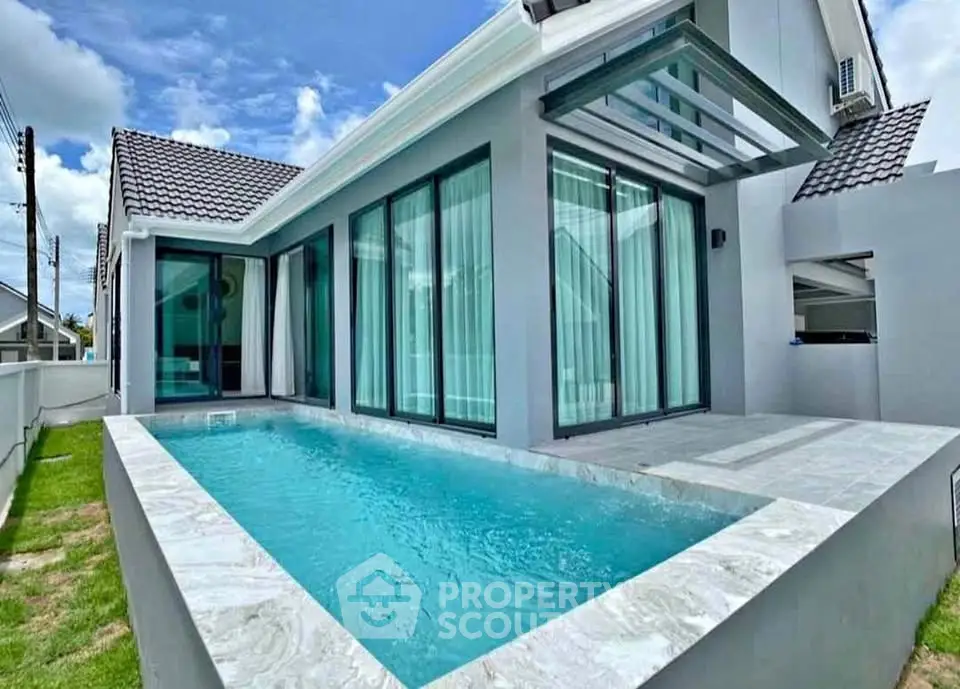 Modern villa with private pool and sleek glass facade, perfect for luxury living.