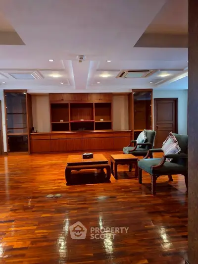 Spacious living room with elegant wooden flooring and stylish furniture