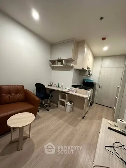 Modern studio apartment with cozy living area and compact kitchen