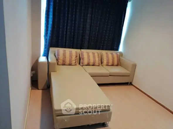 Cozy living room with beige sectional sofa and stylish cushions