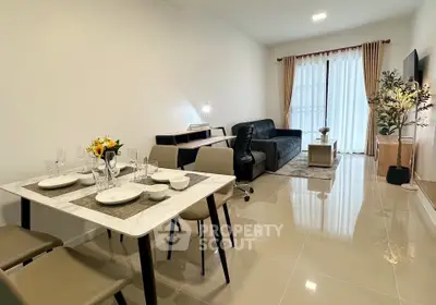 Modern living room with sleek furniture and elegant dining area in a bright open space.
