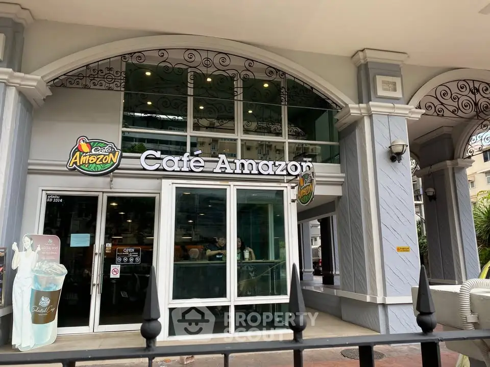 Charming cafe entrance with elegant architectural details and inviting glass doors.
