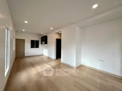Spacious modern living room with wooden flooring and recessed lighting