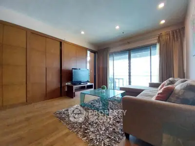 Spacious living room with modern decor and large windows for natural light.