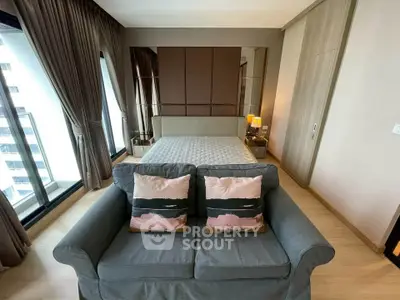 Luxurious bedroom with elegant decor and large windows offering city views