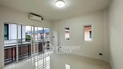 Spacious unfurnished room with large windows and balcony access