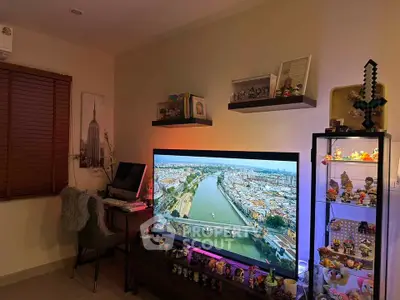 Stylish living room with large TV and display shelves, perfect for entertainment and relaxation.
