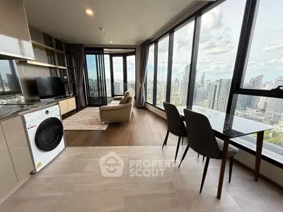 Luxurious high-rise apartment with stunning city view, modern living room, and open kitchen layout.