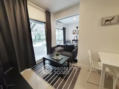 Modern living room with stylish decor and large windows in a contemporary apartment.