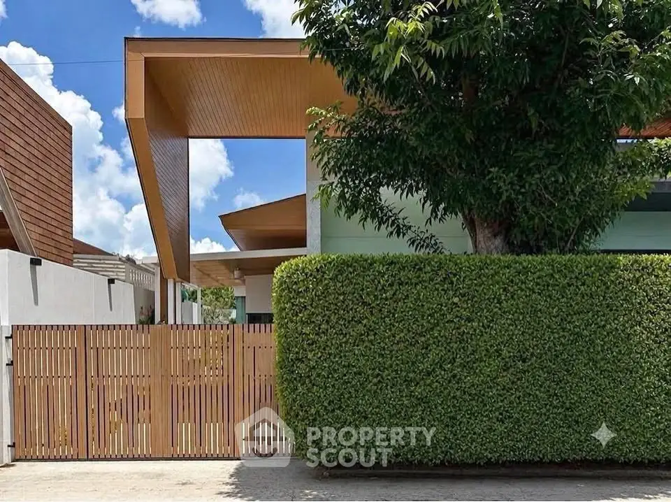 Modern architectural home exterior with lush greenery and wooden accents