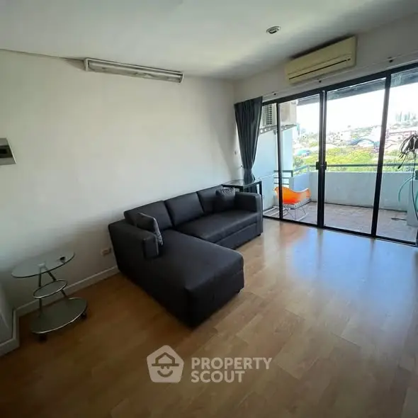 Spacious living room with modern sofa and balcony view