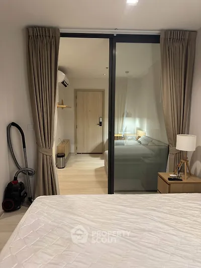 Modern bedroom with glass partition and elegant decor