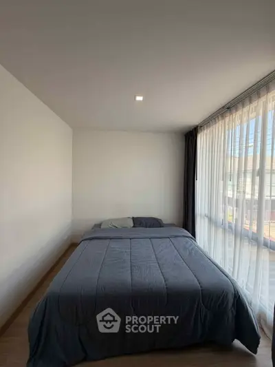 Cozy bedroom with large window and modern decor