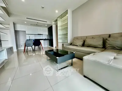 Modern living room with sleek furniture and open kitchen layout