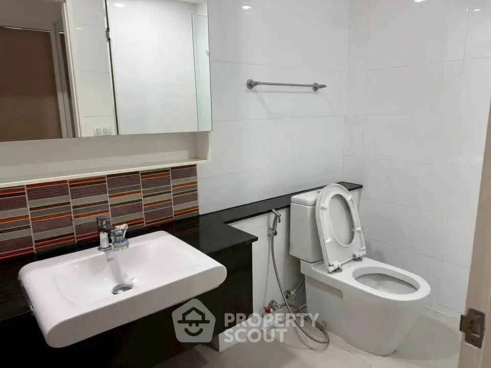 Modern bathroom with sleek fixtures and stylish tile accents