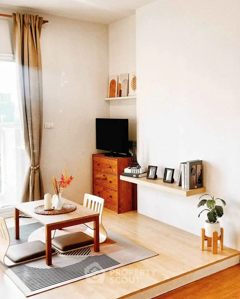 Charming living room with minimalist decor and natural light, featuring a cozy seating area and stylish wooden furniture.