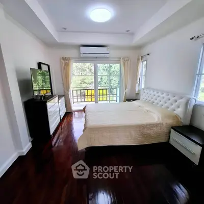 Spacious bedroom with elegant decor and balcony view