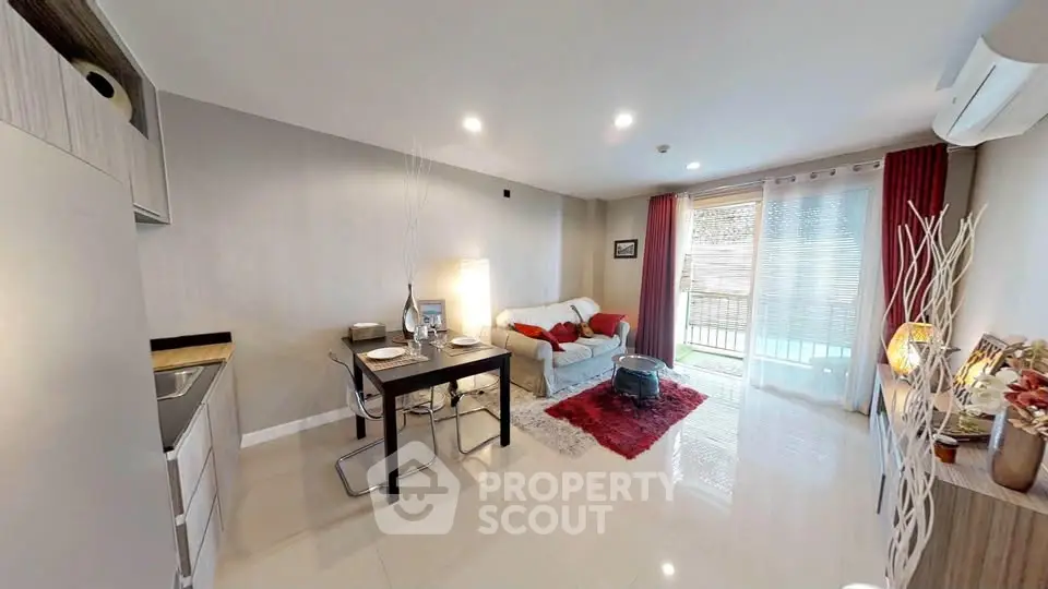 Modern living room with open kitchen and balcony access