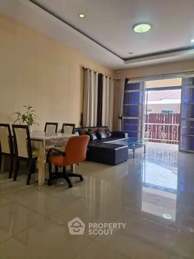 Spacious living room with modern furniture and large windows for natural light.