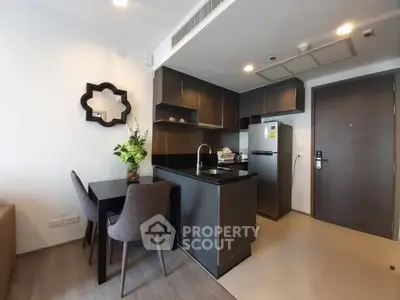 Modern kitchen with sleek design and dining area in stylish apartment