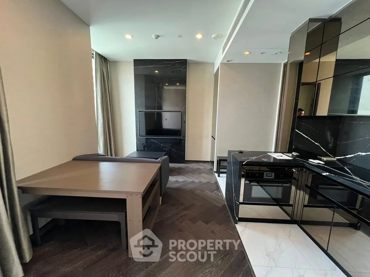 Modern living room with sleek design and integrated kitchen appliances