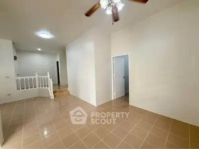 Spacious unfurnished living room with tiled flooring and ceiling fan