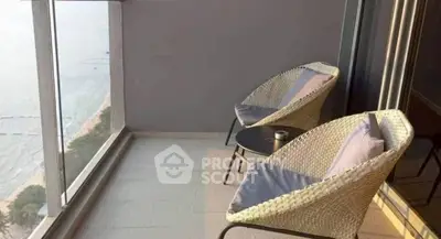 Stunning balcony with ocean view and cozy seating area