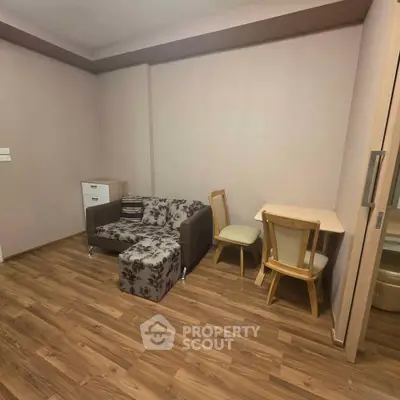 Cozy living room with modern furniture and wooden flooring in a stylish apartment.