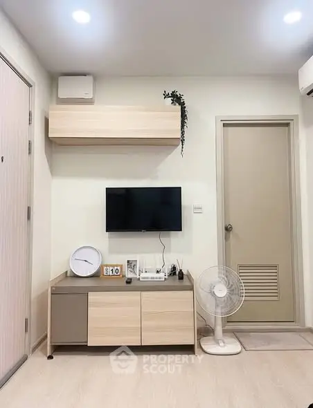 Modern living room with minimalist decor and wall-mounted TV