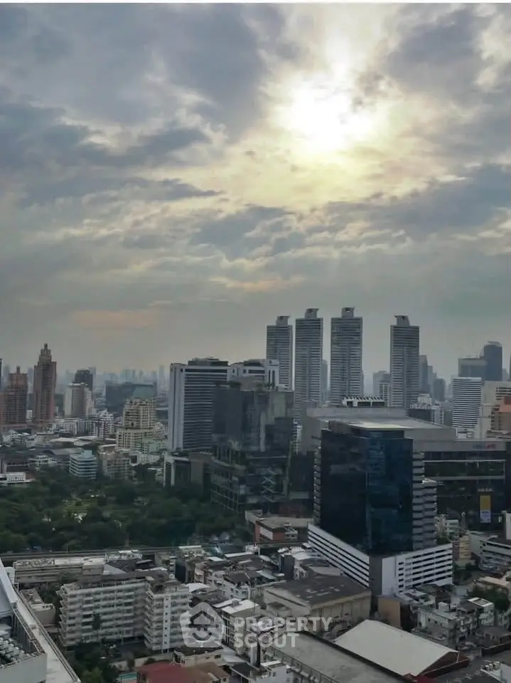 Stunning cityscape view from a high-rise building showcasing urban skyline and dramatic sky.